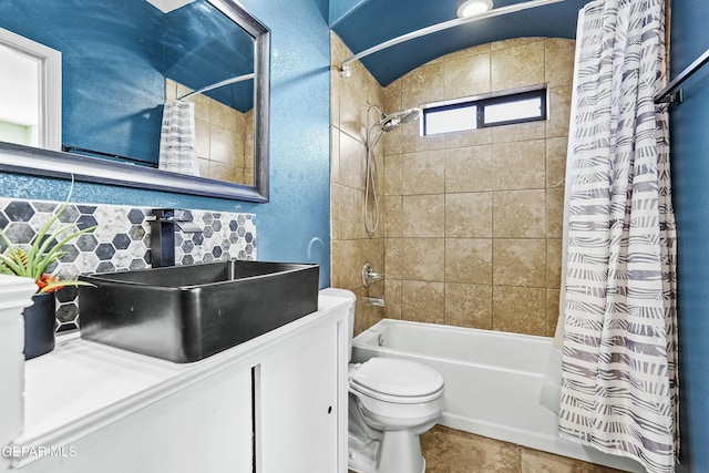 full bathroom featuring tasteful backsplash, shower / bath combo, sink, and toilet