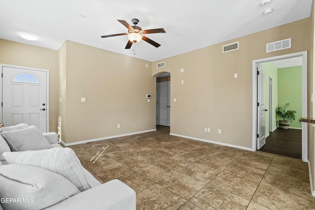 tiled living room with ceiling fan