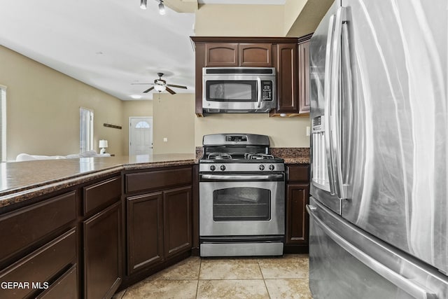 kitchen with light tile patterned floors, dark brown cabinets, stainless steel appliances, and ceiling fan