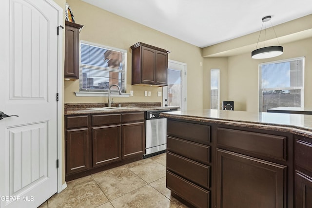 kitchen featuring sink, light tile patterned floors, dishwasher, dark brown cabinets, and decorative light fixtures