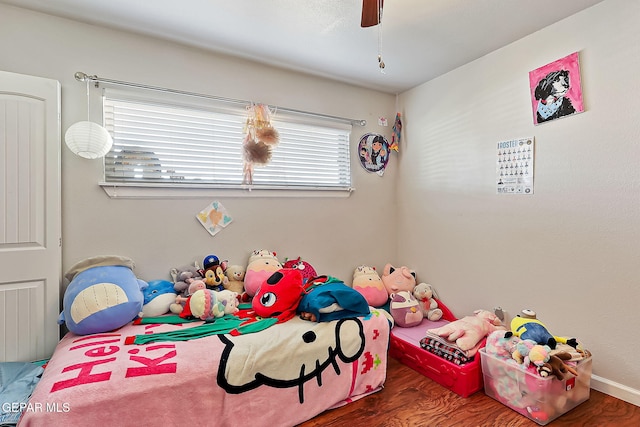 bedroom featuring ceiling fan and dark hardwood / wood-style floors