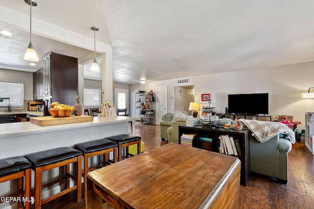 dining area featuring dark hardwood / wood-style floors and a textured ceiling