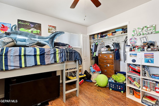 bedroom with wood-type flooring, a closet, and ceiling fan