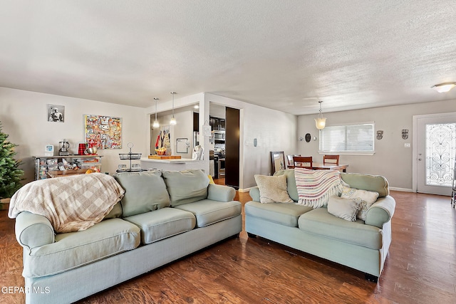 living room featuring dark hardwood / wood-style floors and a textured ceiling