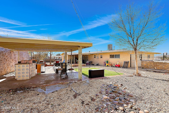 exterior space featuring central air condition unit and a patio area