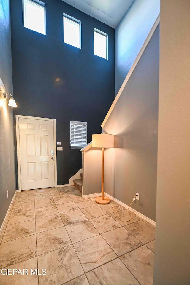 1009 Earthstar Pl, El Paso, TX 79928 - foyer featuring baseboards, a towering ceiling, and stairs