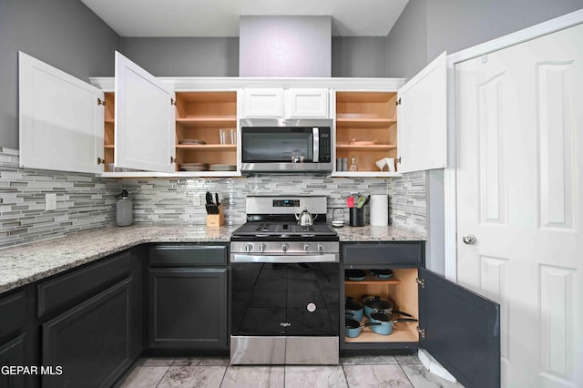 1009 Earthstar Pl, El Paso, TX 79928 - kitchen with open shelves, tasteful backsplash, light stone counters, and stainless steel appliances