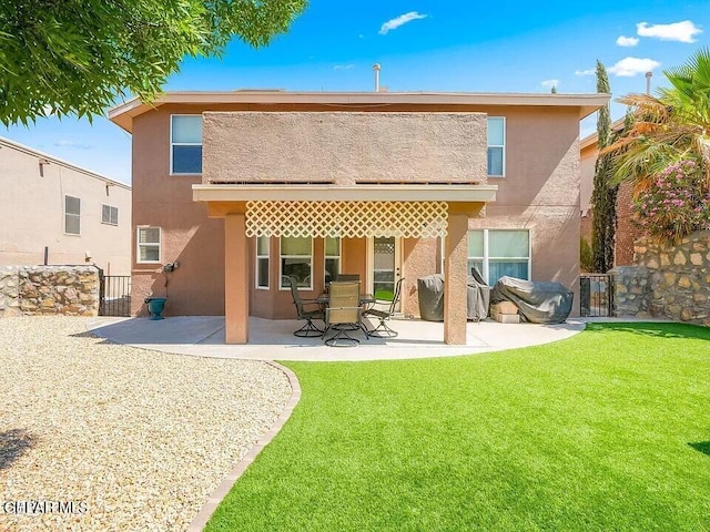 rear view of property with a patio area and a lawn