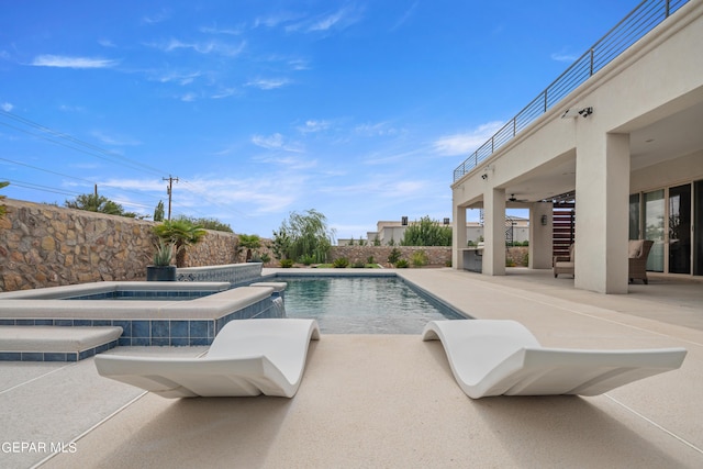 view of swimming pool with a fenced in pool, a patio area, fence, and an in ground hot tub