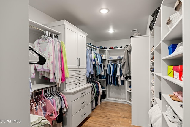 spacious closet featuring light wood-type flooring and visible vents