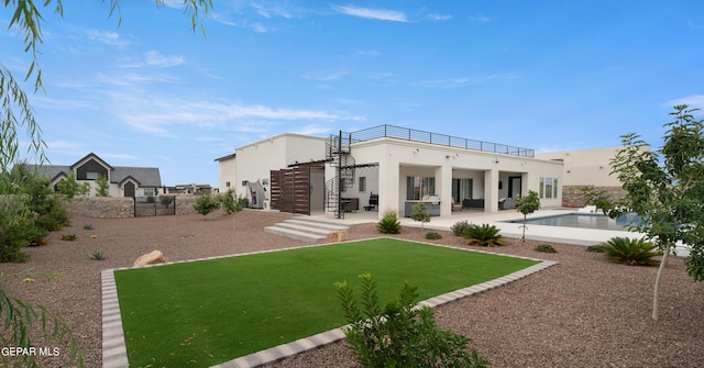 rear view of house featuring an outdoor pool, fence, stairs, stucco siding, and a patio area