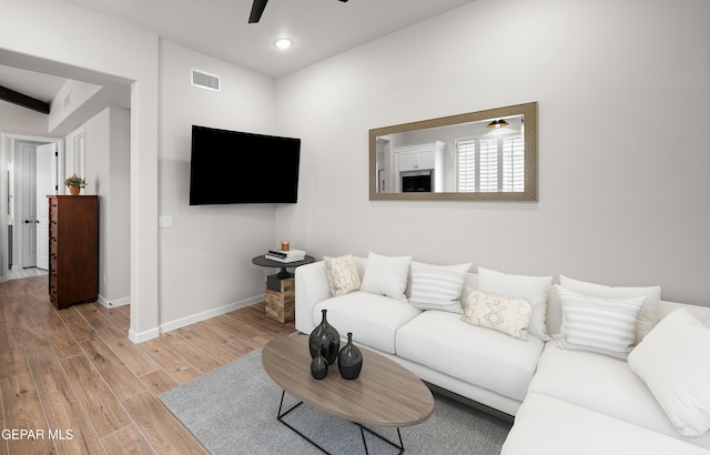 living area with recessed lighting, visible vents, light wood-style flooring, a ceiling fan, and baseboards