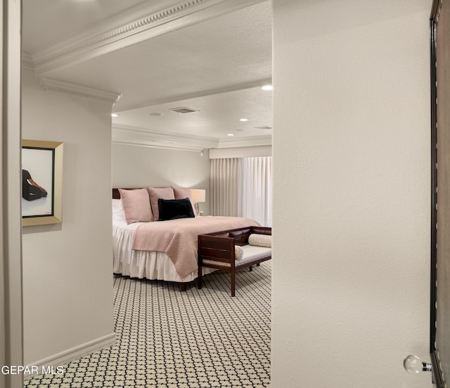 bedroom with baseboards, visible vents, crown molding, and carpet flooring