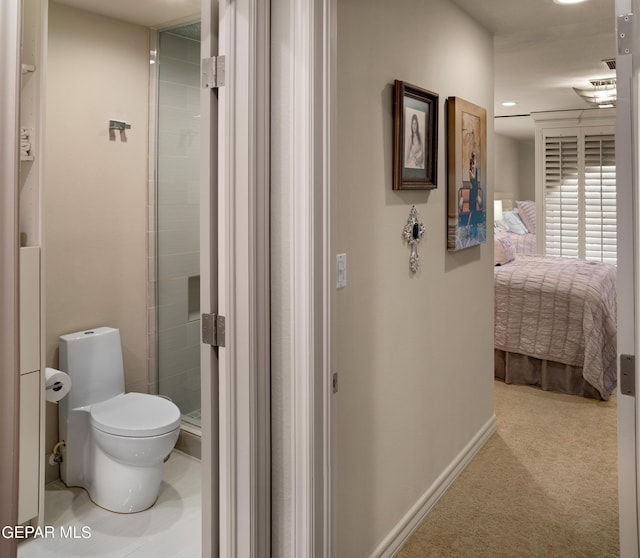 hallway featuring carpet floors and baseboards