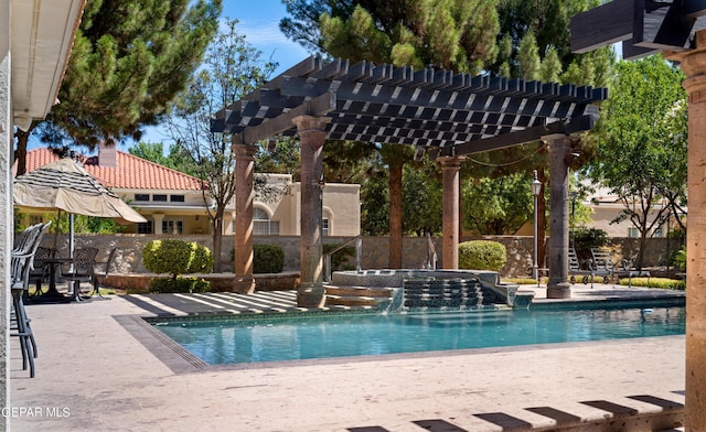 community pool featuring a patio area, fence, and a pergola