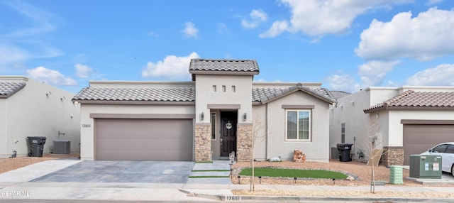 mediterranean / spanish-style home featuring cooling unit and a garage