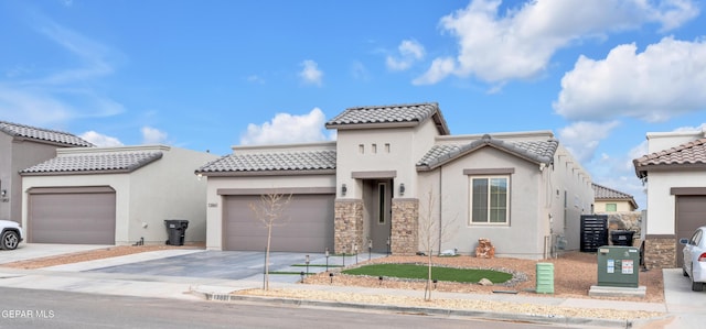 mediterranean / spanish-style house with a garage