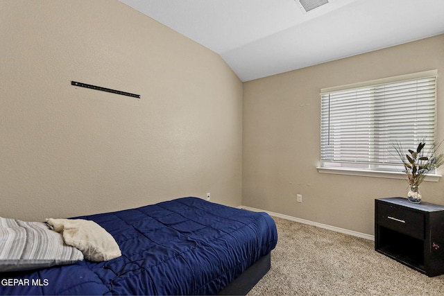 bedroom with lofted ceiling and light carpet