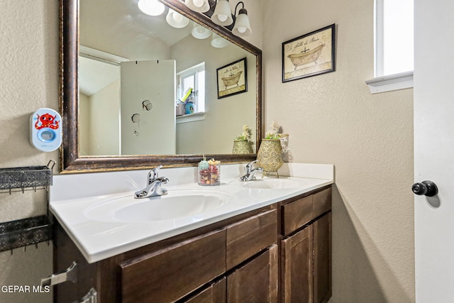 bathroom featuring vanity and vaulted ceiling