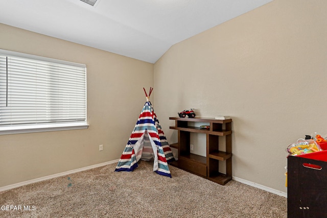 recreation room featuring vaulted ceiling and carpet flooring