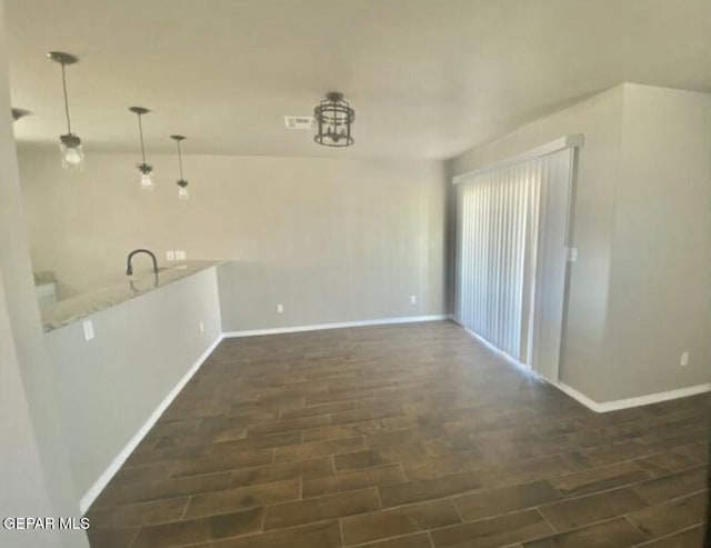 unfurnished dining area featuring dark wood-type flooring