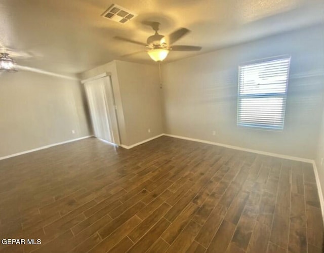 unfurnished room featuring ceiling fan and dark hardwood / wood-style floors