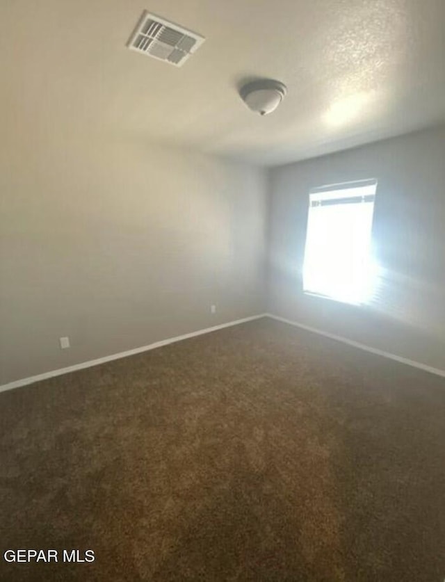 spare room featuring carpet floors