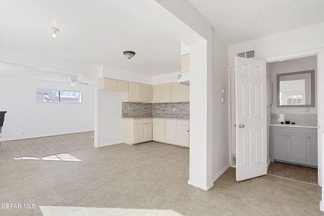 interior space with tasteful backsplash and ceiling fan