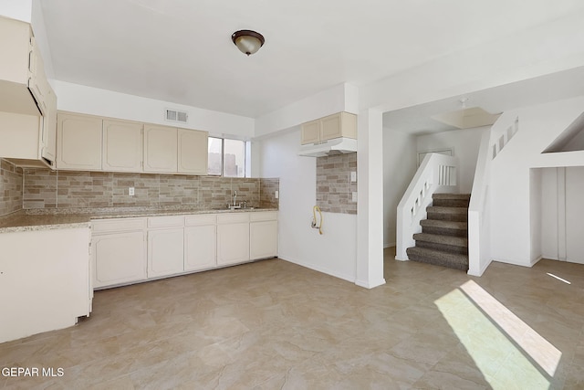 kitchen featuring sink and decorative backsplash