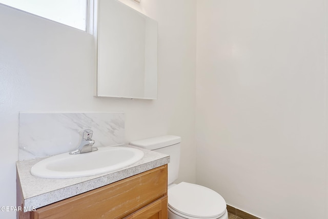 bathroom featuring vanity and toilet