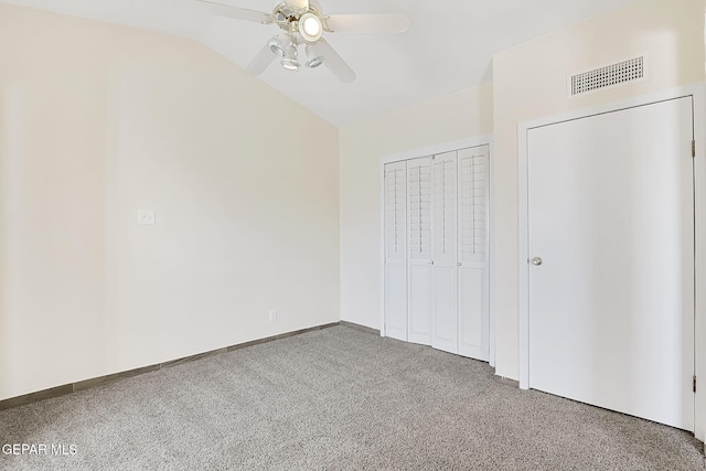 unfurnished bedroom with ceiling fan, lofted ceiling, and carpet floors