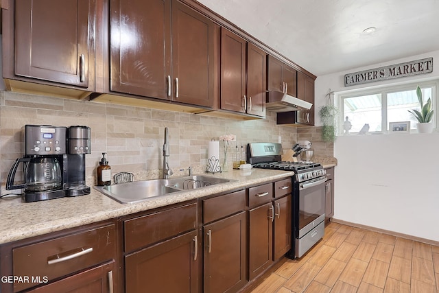 kitchen with tasteful backsplash, dark brown cabinetry, sink, and stainless steel gas range oven