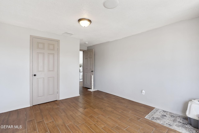 spare room with a textured ceiling