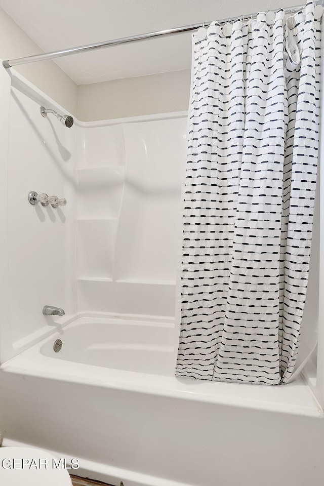 bathroom featuring shower / tub combo with curtain