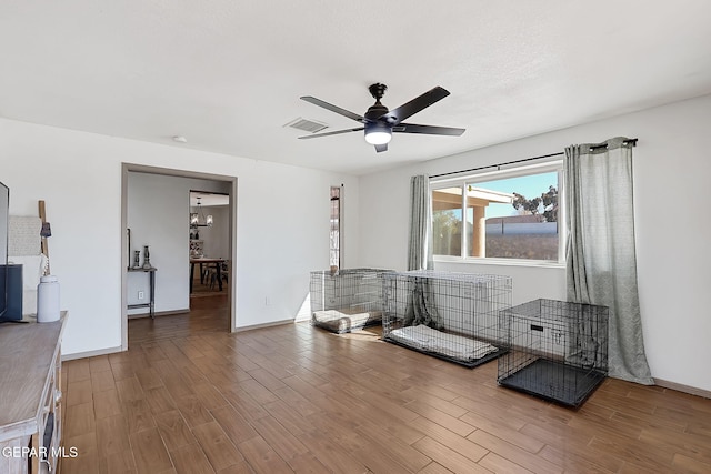 interior space with ceiling fan with notable chandelier