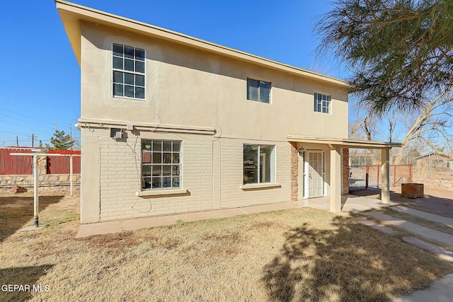 back of house with a patio