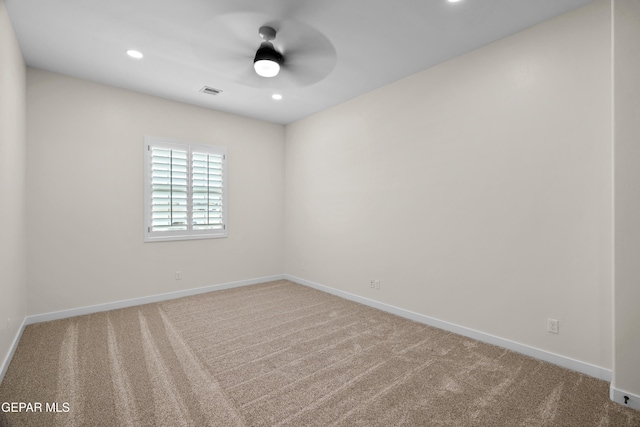 spare room with carpet floors, recessed lighting, visible vents, and baseboards