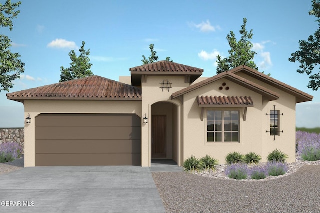 mediterranean / spanish home with a garage, concrete driveway, and stucco siding