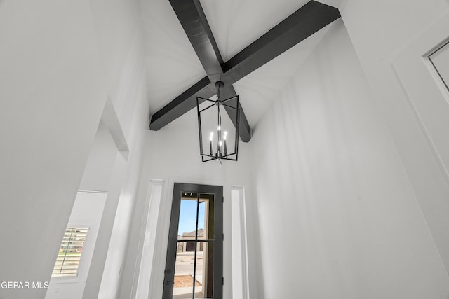 room details featuring a chandelier and beamed ceiling