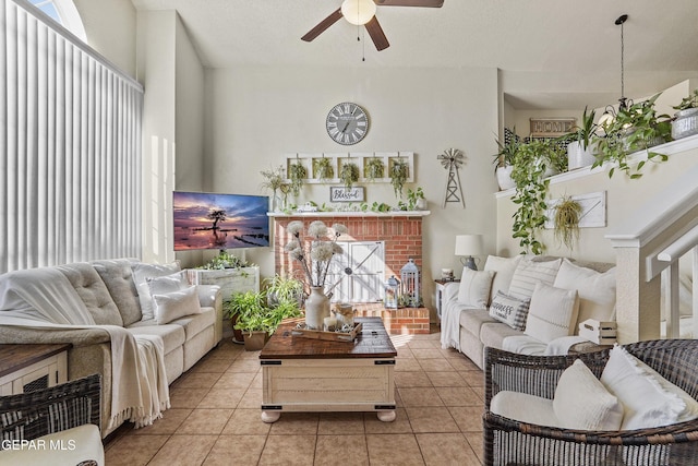 tiled living room with a brick fireplace, a wealth of natural light, and ceiling fan