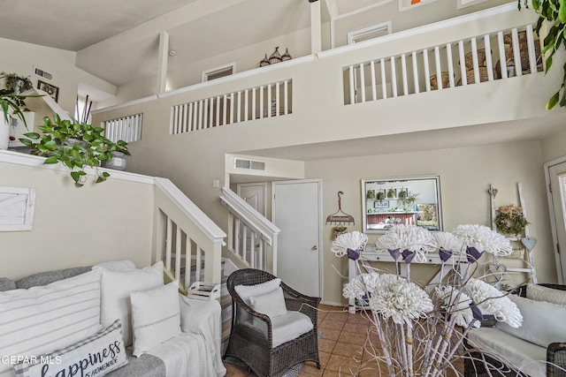 living room featuring tile patterned floors and a high ceiling