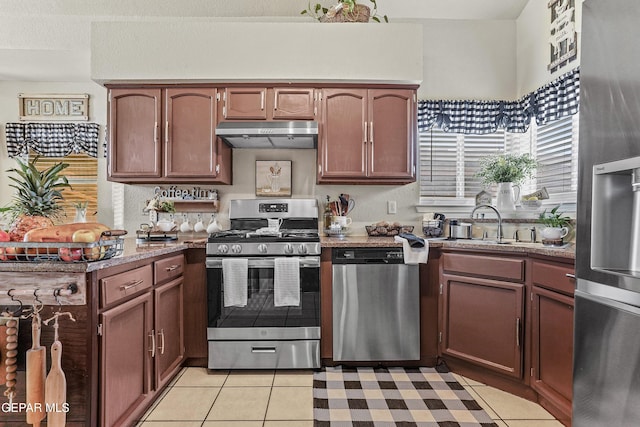 kitchen with stainless steel appliances, sink, and light tile patterned floors