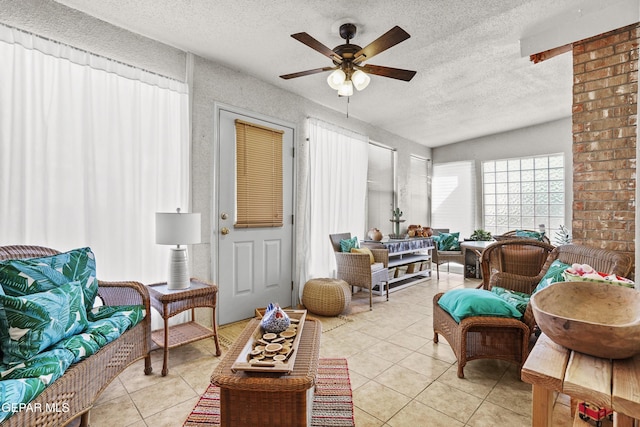 living area with light tile patterned floors, a textured ceiling, and ceiling fan