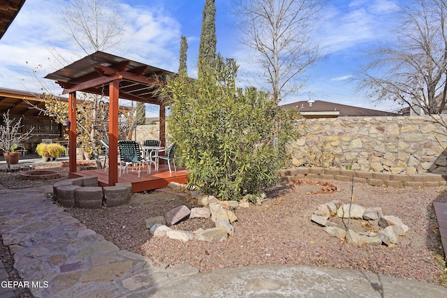 view of yard with a fire pit and a deck