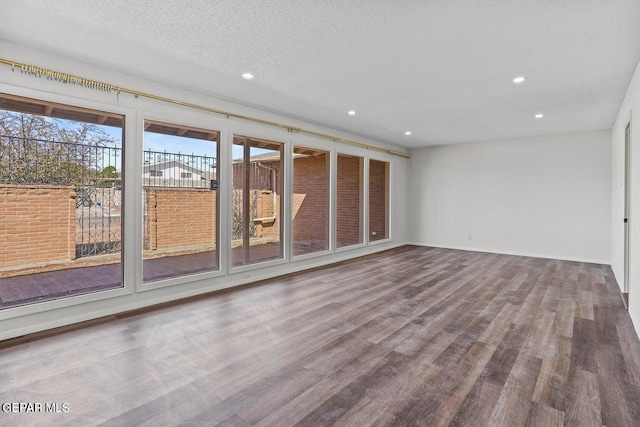 interior space with recessed lighting, wood finished floors, and a textured ceiling