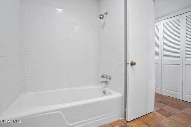 full bathroom featuring washtub / shower combination and a textured ceiling