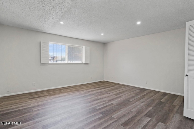 empty room featuring baseboards, recessed lighting, and dark wood finished floors
