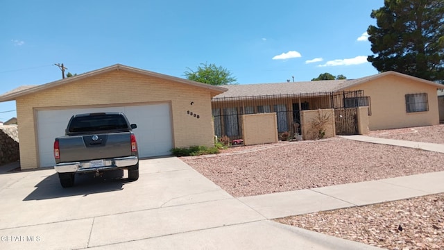 8808 Cosmos Ave, El Paso, TX 79925 - ranch-style home with brick siding, a garage, driveway, and a gate