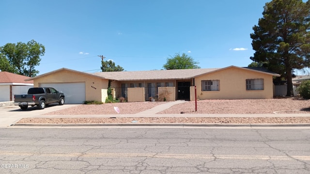 8808 Cosmos Ave, El Paso, TX 79925 - ranch-style house featuring concrete driveway, an attached garage, and stucco siding