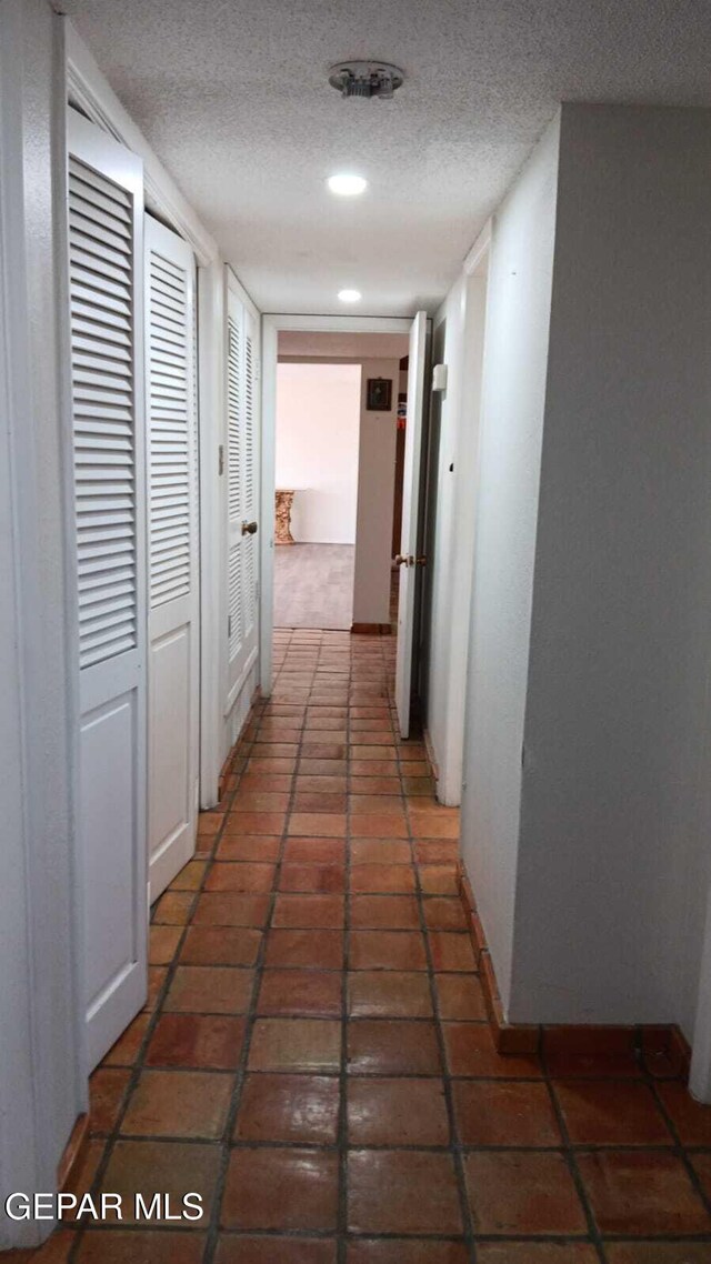 8808 Cosmos Ave, El Paso, TX 79925 - hall with a textured ceiling, baseboards, and recessed lighting